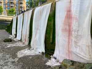 Installation view of Mary Lemley's banners on the Thames foreshore